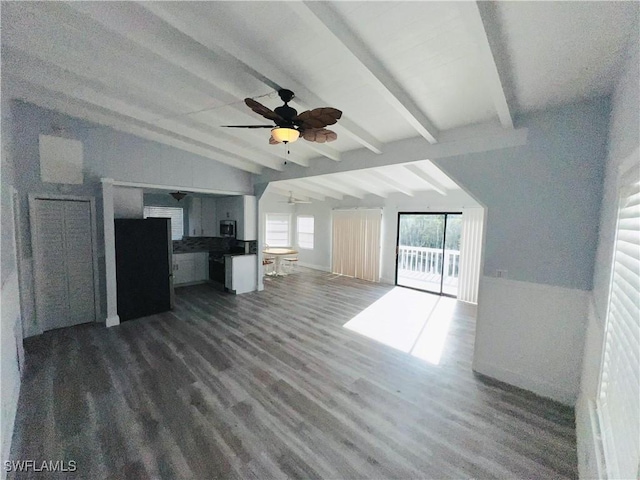 unfurnished living room featuring ceiling fan, dark hardwood / wood-style flooring, and lofted ceiling with beams