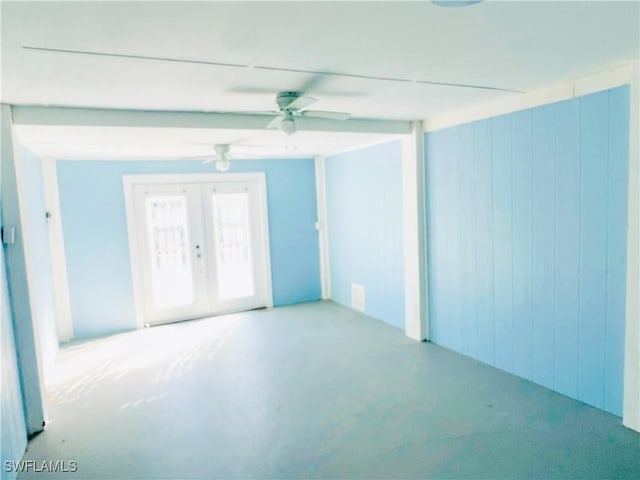 empty room with ceiling fan and french doors