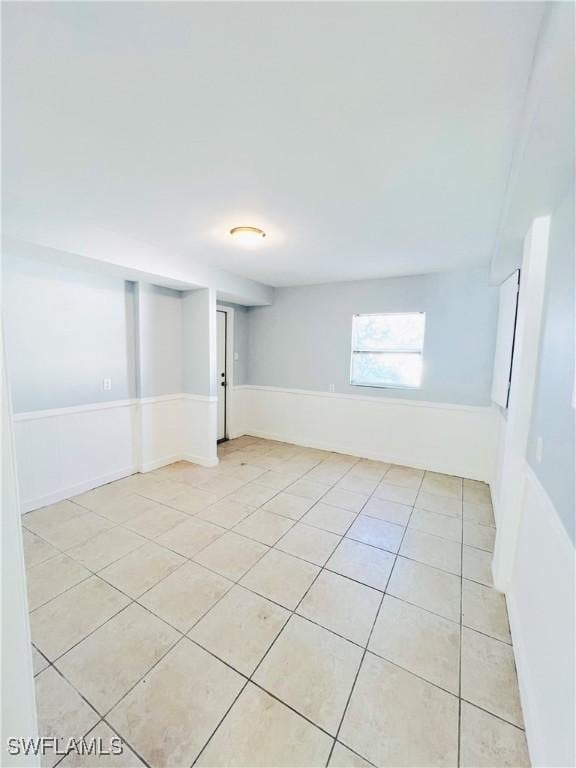 basement featuring light tile patterned floors