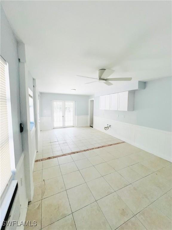 spare room featuring light tile patterned floors and ceiling fan