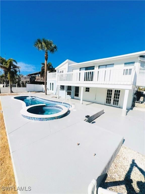 view of pool featuring an in ground hot tub and a patio