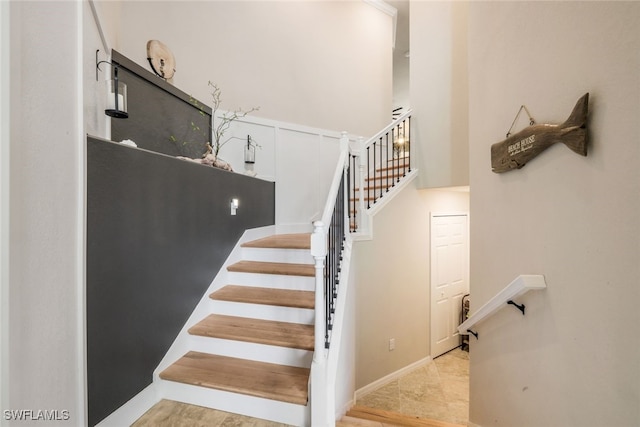 stairway with tile patterned floors