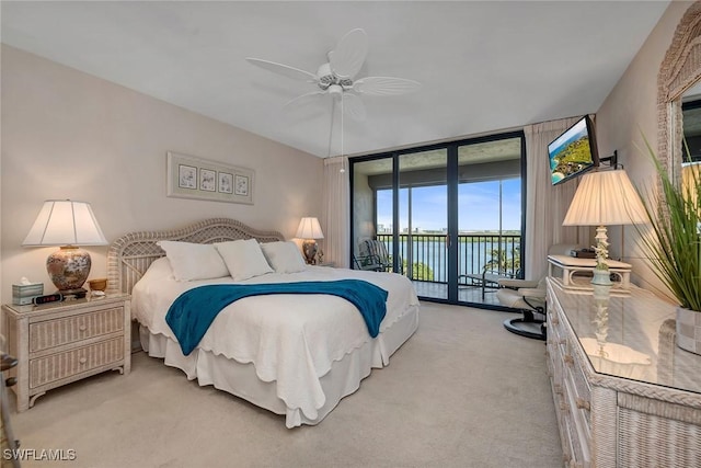 carpeted bedroom featuring ceiling fan, floor to ceiling windows, and access to outside