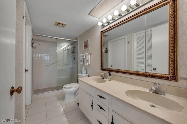 bathroom featuring vanity, a shower with door, tile patterned flooring, and toilet