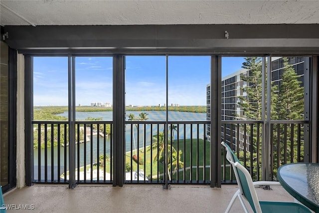 unfurnished sunroom with a water view and a wealth of natural light