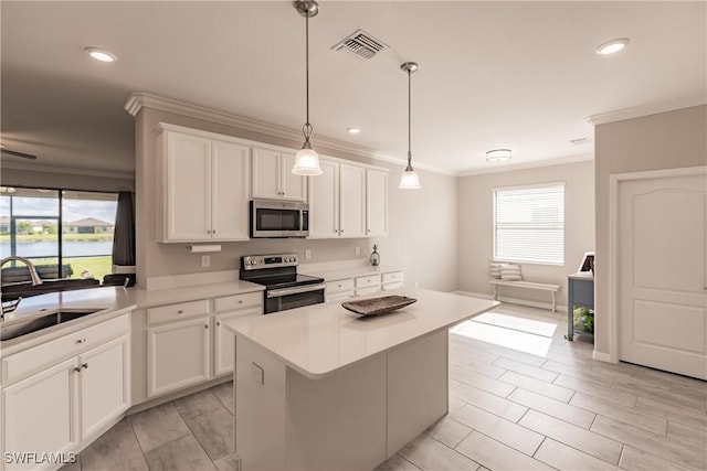 kitchen with a center island, white cabinetry, sink, and appliances with stainless steel finishes