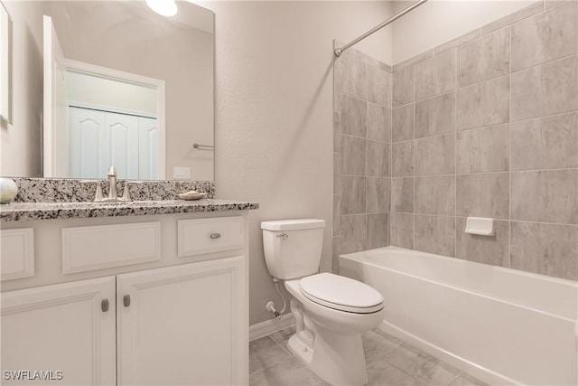 full bathroom featuring tiled shower / bath combo, toilet, and vanity