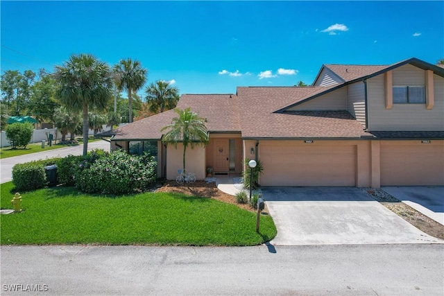 view of front of house featuring a garage and a front yard