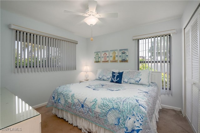 bedroom featuring light colored carpet, a closet, and ceiling fan