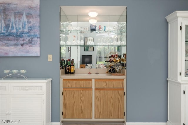 bar featuring light brown cabinets