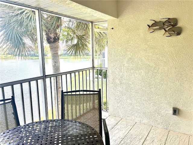 unfurnished sunroom with a water view