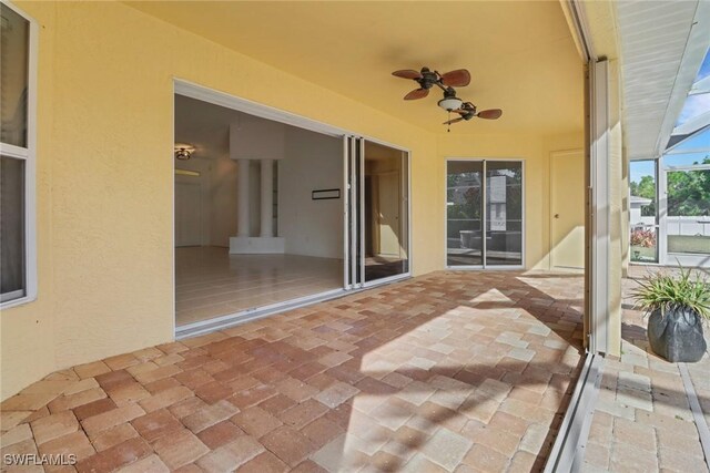 view of patio / terrace with ceiling fan and a lanai