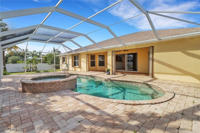 view of swimming pool with a lanai, a patio area, and an in ground hot tub