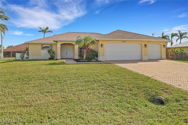 single story home with an attached garage, decorative driveway, a front yard, and stucco siding