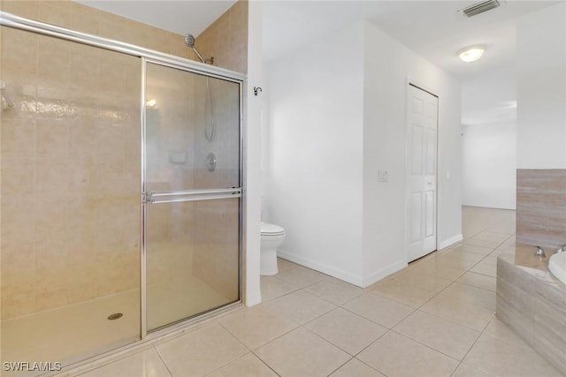 bathroom featuring toilet, a stall shower, visible vents, and tile patterned floors