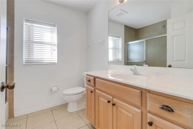 bathroom with toilet, tile patterned floors, and vanity