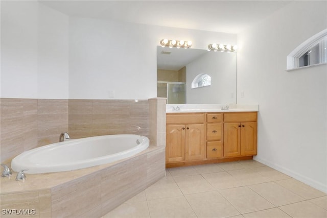 bathroom with double vanity, a stall shower, a sink, a bath, and tile patterned floors