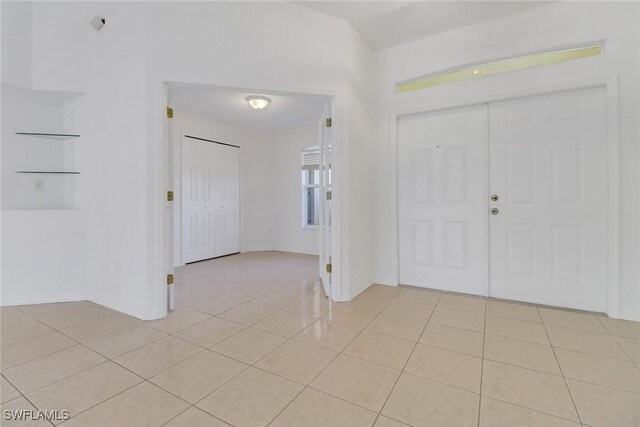 entryway with light tile patterned floors