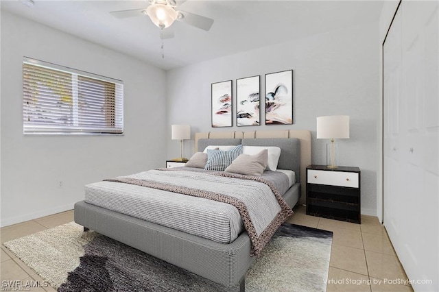 bedroom featuring a ceiling fan, baseboards, and light tile patterned floors