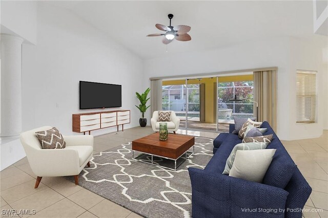 tiled living room with ceiling fan, decorative columns, and high vaulted ceiling