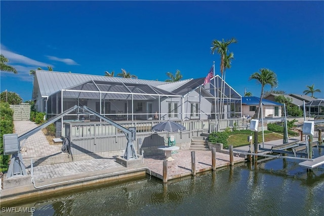 dock area with glass enclosure and a water view