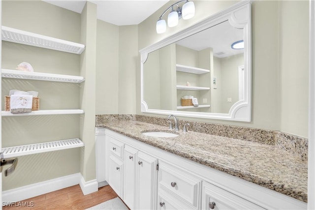 bathroom with vanity and hardwood / wood-style flooring