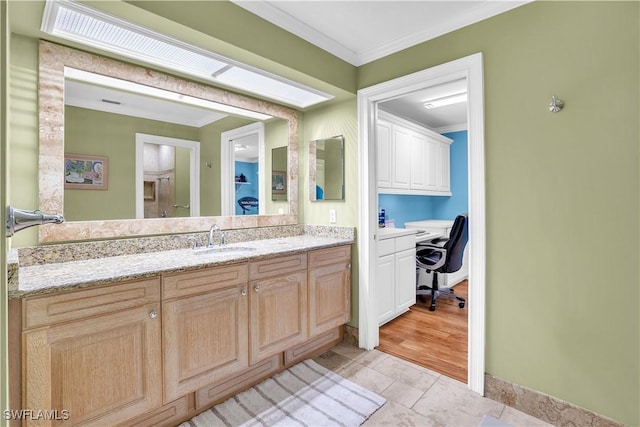 bathroom featuring ornamental molding and sink