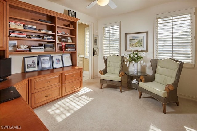 sitting room featuring light carpet, plenty of natural light, and ceiling fan