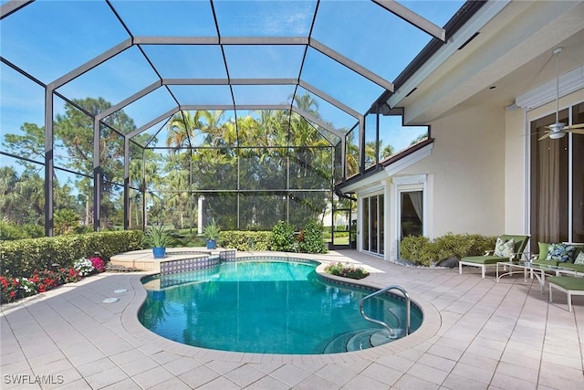 view of swimming pool with a lanai, a patio, and a hot tub