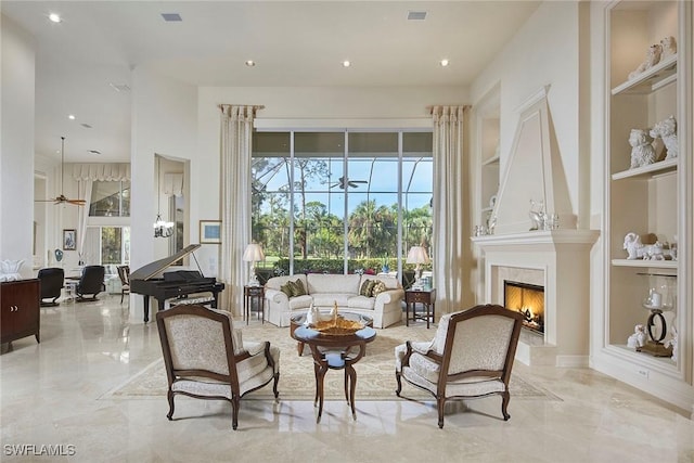 living area featuring built in shelves, a fireplace, and plenty of natural light