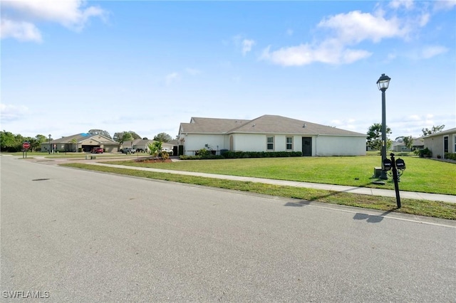 ranch-style house featuring a front yard