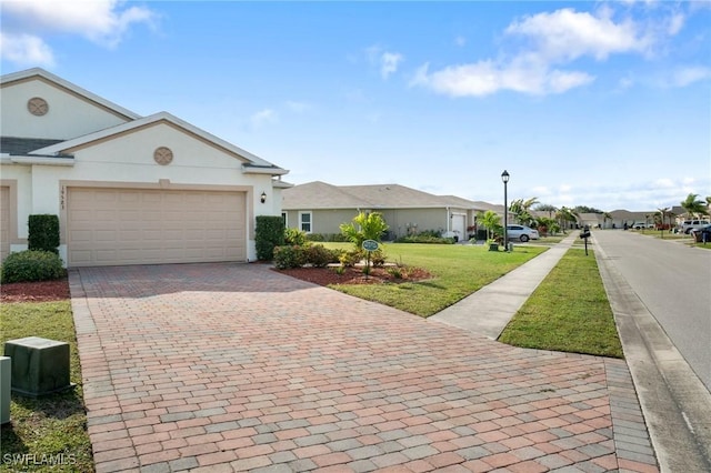 ranch-style house featuring a front yard and a garage