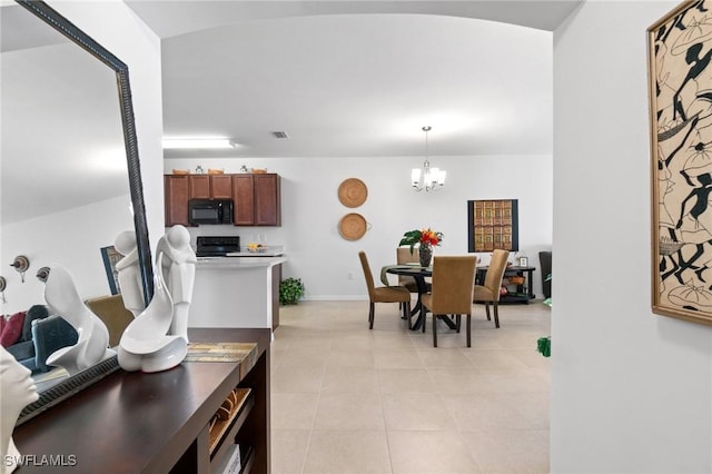 dining room featuring a chandelier and light tile patterned flooring