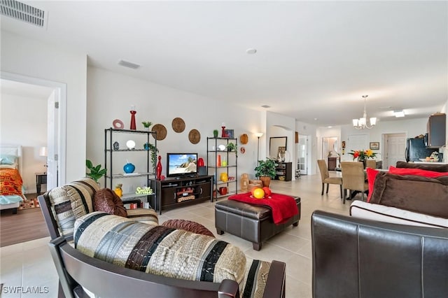 tiled living room with a chandelier