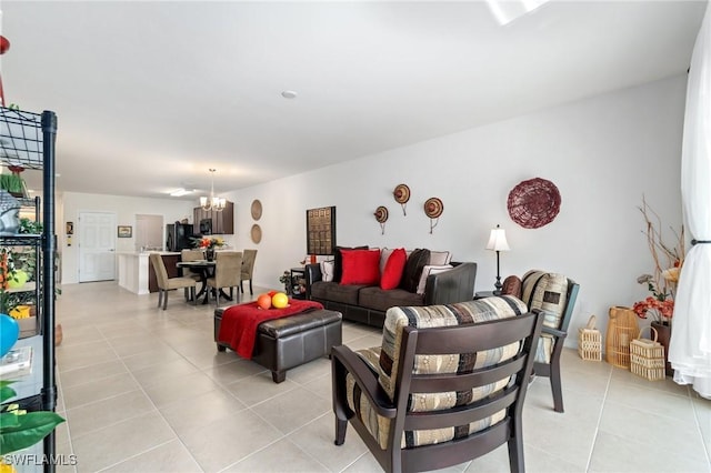 living room featuring light tile patterned floors and an inviting chandelier