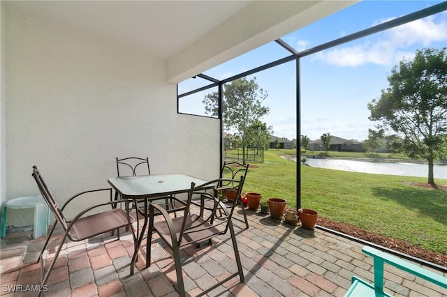 sunroom / solarium with a water view