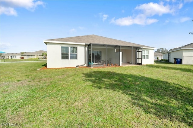 rear view of property featuring a lanai and a yard