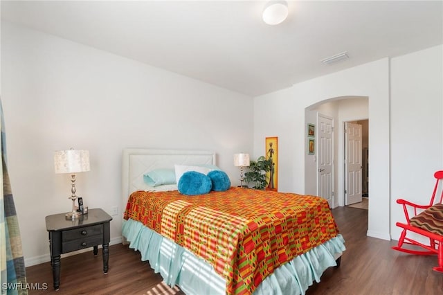 bedroom with dark wood-type flooring