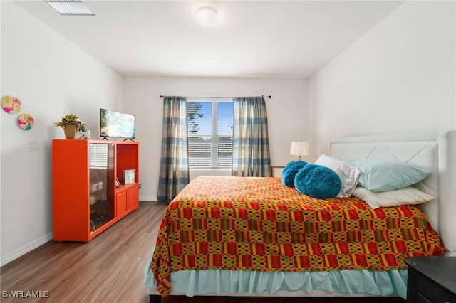 bedroom featuring wood-type flooring