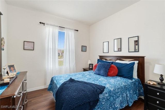 bedroom with dark wood-type flooring