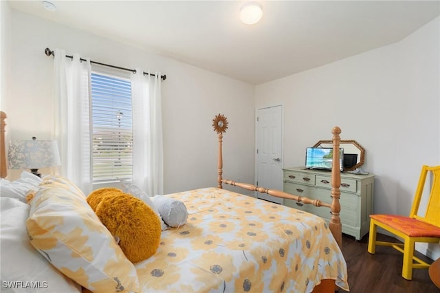 bedroom with dark wood-type flooring