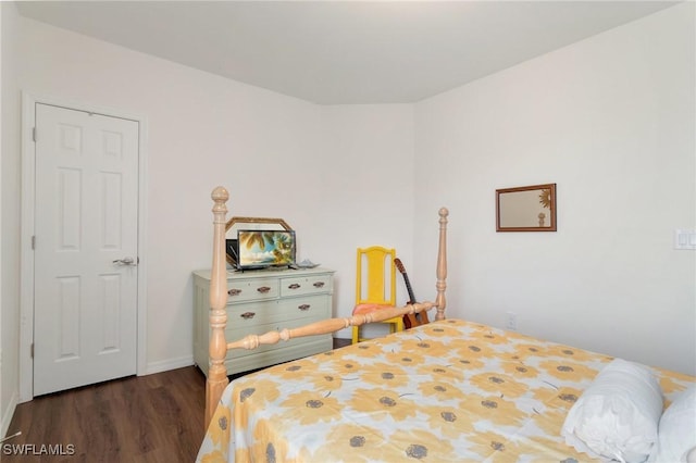 bedroom with dark hardwood / wood-style flooring