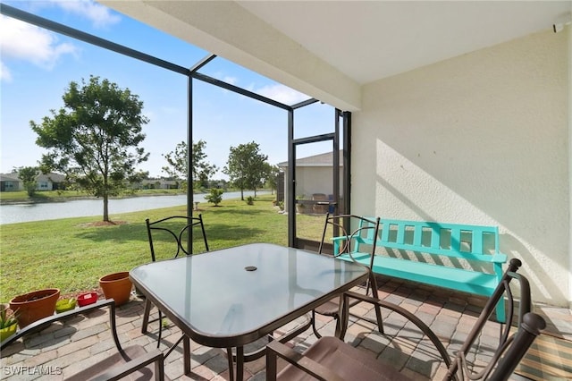 sunroom / solarium with a water view