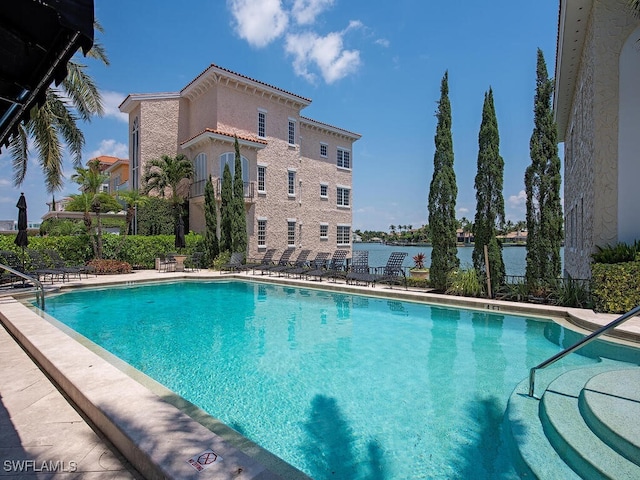 view of pool with a water view