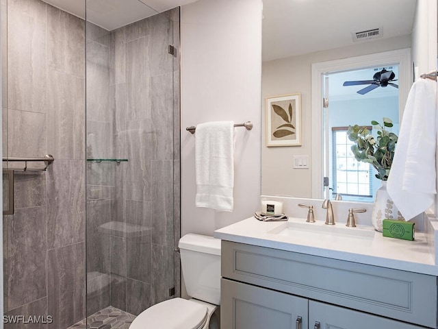 bathroom featuring toilet, walk in shower, and vanity