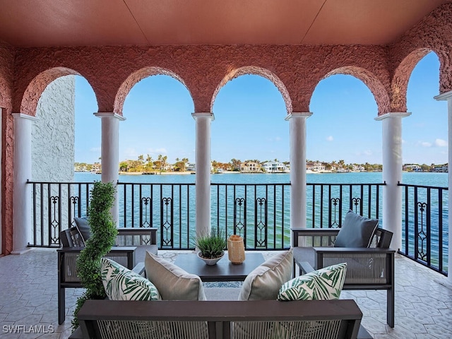 balcony featuring outdoor lounge area and a water view