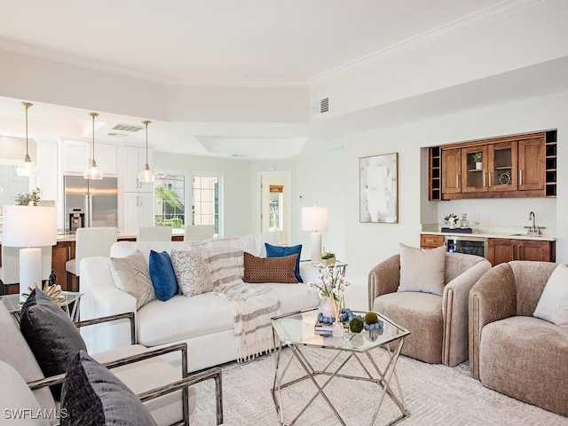 living room with crown molding and sink