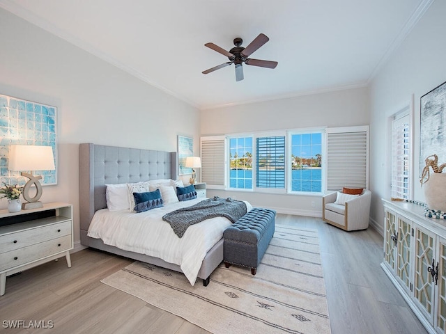 bedroom featuring ceiling fan, light hardwood / wood-style floors, and crown molding