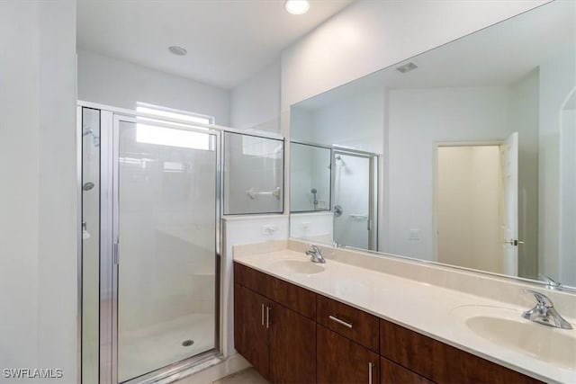 bathroom featuring vanity and a shower with shower door