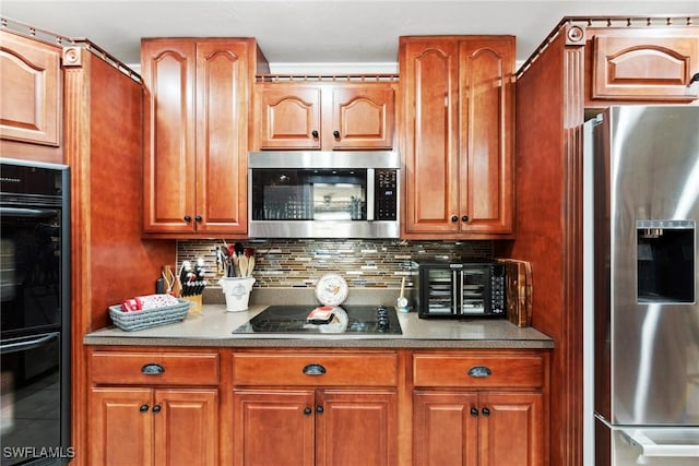 kitchen featuring decorative backsplash and black appliances